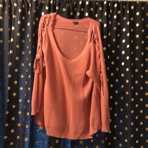 Pink oversized sweater tie closures on sleeves